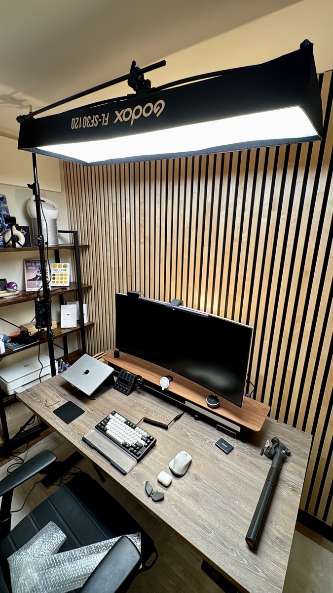 Desk setup with monitor, keyboard and studio light